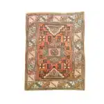 Coral-red turkish carpet with a central star medallion and geometric diagonal border.