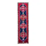 Red turkish carpet runner with navy diamond medallions and a floral border.
