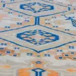 turkish carpet with bird motifs, and an orange-blue geometric border.