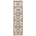 turkish carpet with brown diamond and zigzag patterns and a checkered border.