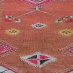 turkish carpet with tree motifs, and an orange-gold border.