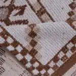 turkish carpet with zigzag patterns and a checkered border.