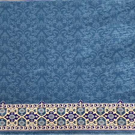 Blue mosque carpet with floral vines and ornate border.